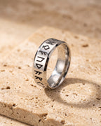 Atlas Norse rune band ring standing on warm stone