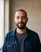Man in a denim jacket over a charcoal T-shirt wearing the silver-tone Atlas O-link chain