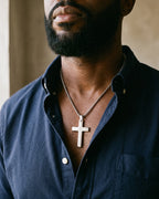 Atlas Our Father engraved cross pendant necklace in silver-tone titanium steel worn on the chest, close-up