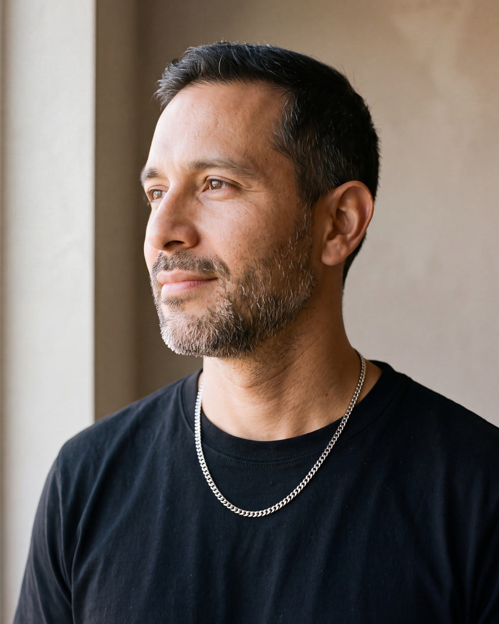 Man in a black T-shirt by a window wearing the 5 mm silver Atlas polished Cuban chain