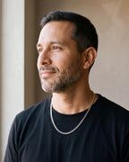 Man in a black T-shirt by a window wearing the 5 mm silver Atlas polished Cuban chain