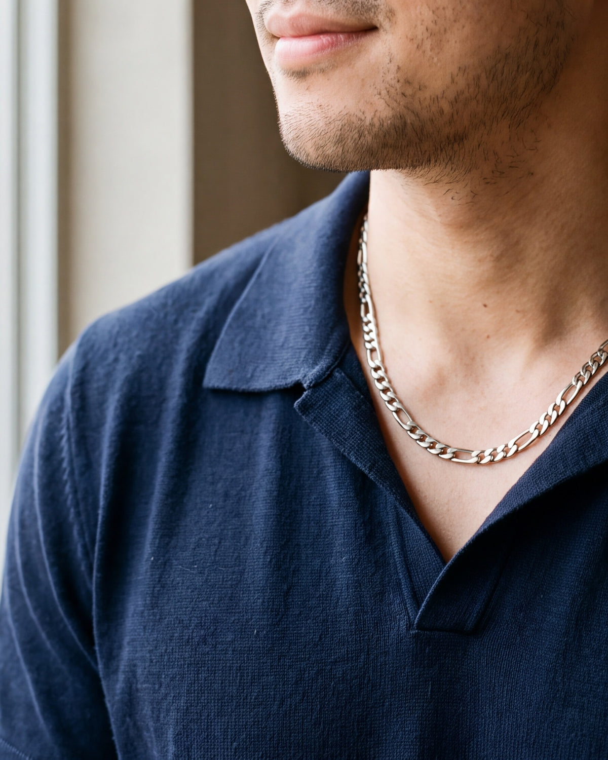 Close-up of the silver Atlas polished figaro chain worn at true size