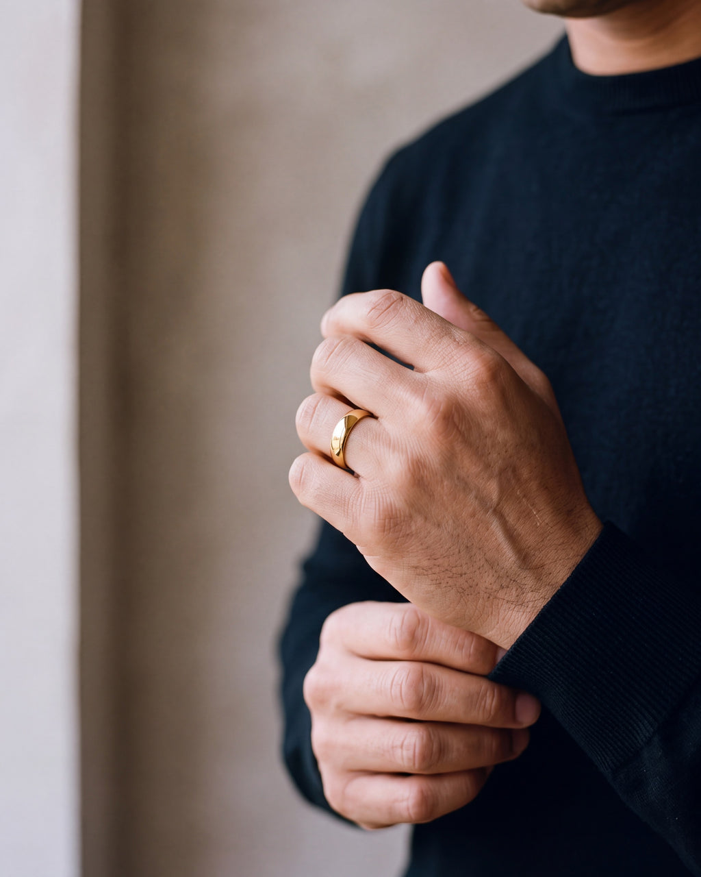 Close-up of the gold-tone Atlas polished gold-tone band ring worn at true size