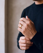 Close-up of the gold-tone Atlas polished gold-tone band ring worn at true size