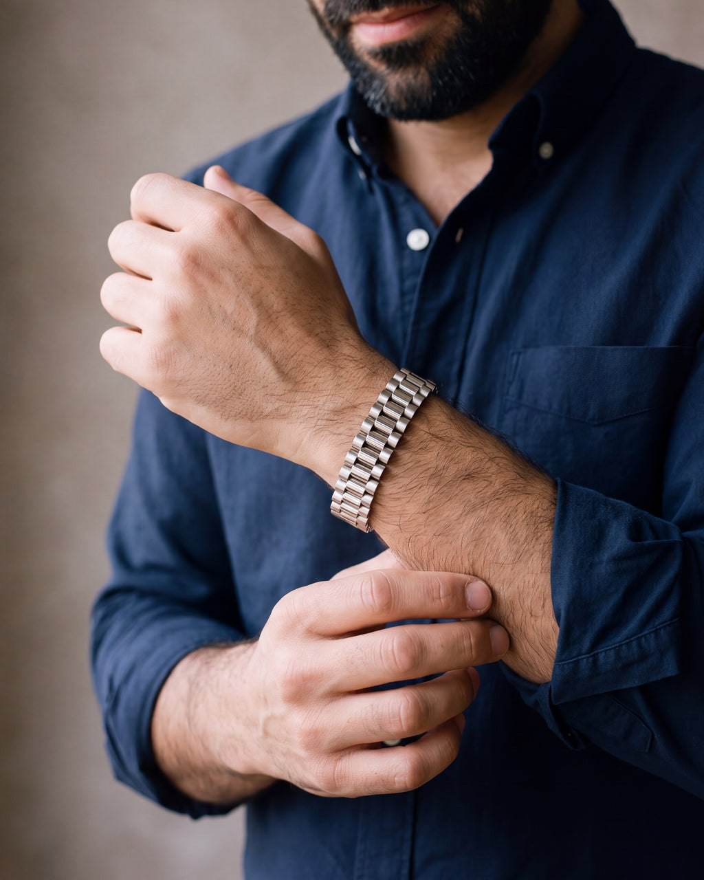 Close-up of the silver Atlas President link bracelet on a man's wrist at true size
