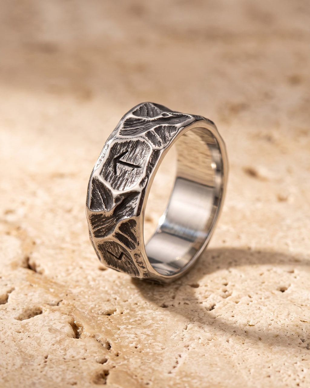 The Atlas rock texture rune ring standing on warm stone