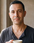 Man in a charcoal henley holding a coffee cup, wearing the 2.5 mm gold-tone Atlas rope chain