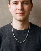 Man in a charcoal sweater looking at the camera, wearing the 5 mm Atlas rope chain