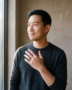 Man in a charcoal fine-gauge knit crew-neck sweater wearing the rose gold-tone Atlas Rose Gold-Tone Groove Ring