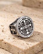 The whole antiqued silver Atlas Saint Benedict signet ring laid on warm stone