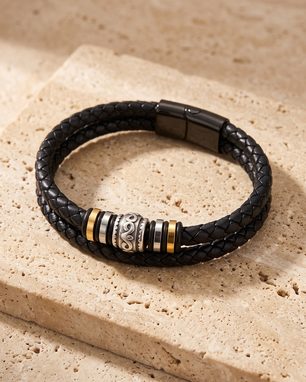 The whole black Atlas scrollwork bead braided leather bracelet laid on warm stone
