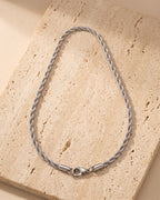 The whole silver Atlas spiral rope chain laid on warm stone