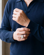 Close-up of the Atlas square top ring in silver-tone steel, worn at true size