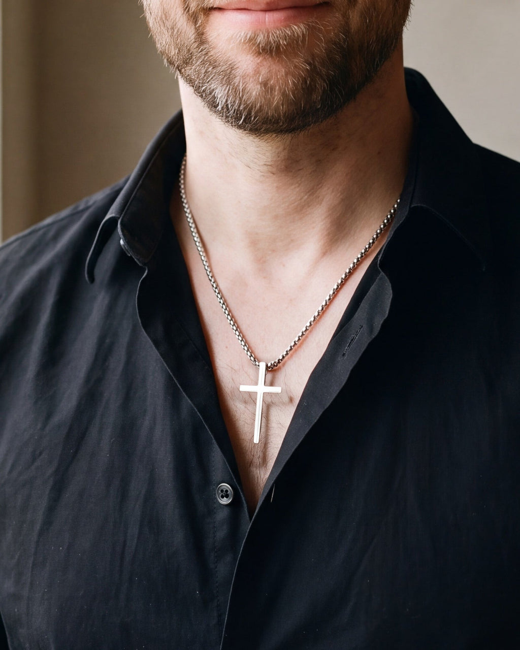 Close-up of the Atlas minimal cross pendant necklace (Large) in silver-tone steel worn, true size