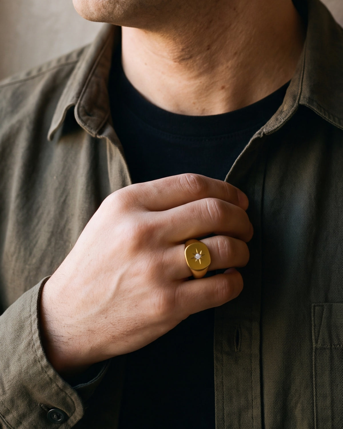 Close-up of the Atlas star signet ring on a man's hand