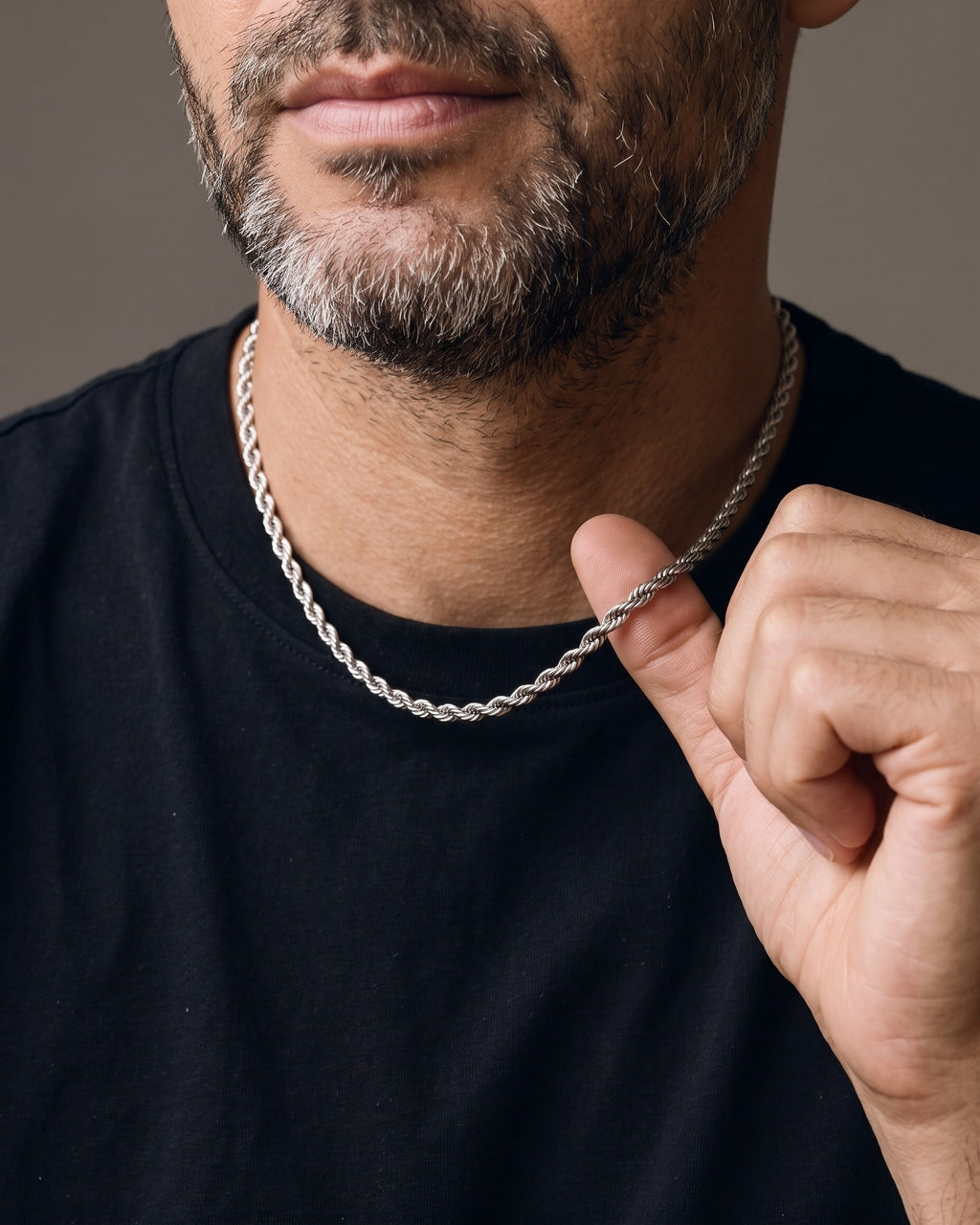Hand lifting the Atlas Titanium Steel Rope Chain at the collarbone