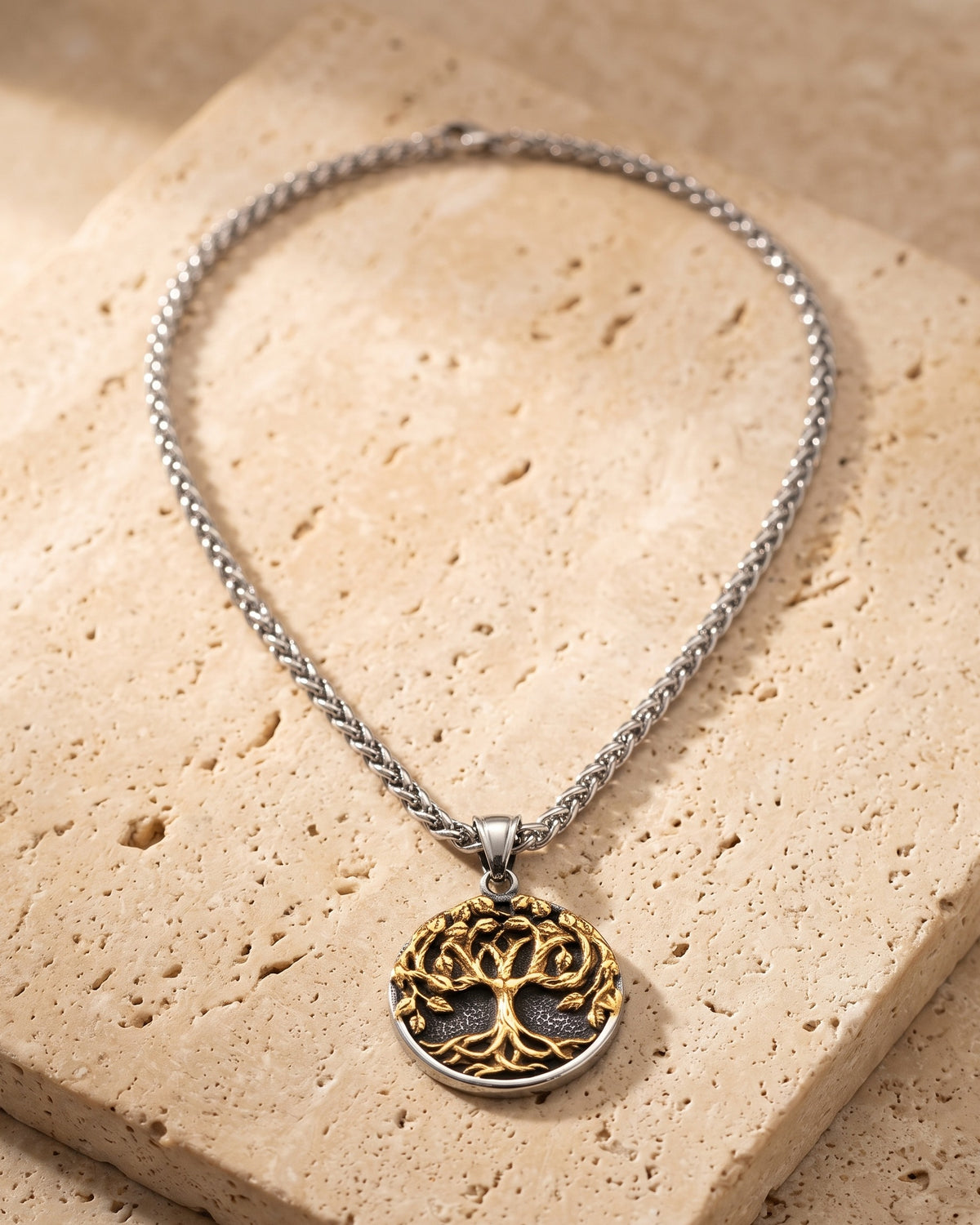 The whole Atlas two-tone tree of life pendant necklace on warm stone, wheat chain