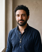 Man in a navy shirt wearing the silver Atlas trident pendant necklace