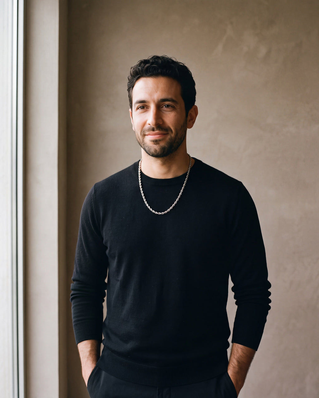 Man in a black merino crew-neck sweater wearing the silver Atlas Twisted Rope Chain