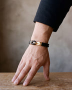 Close-up of the smooth leather Atlas two-strand bracelet and its gold-tone hook on a man's wrist [c:smoothgoldtone]