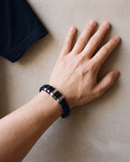 Close-up of the silver-tone Atlas two-tone bar braided leather bracelet worn at true size