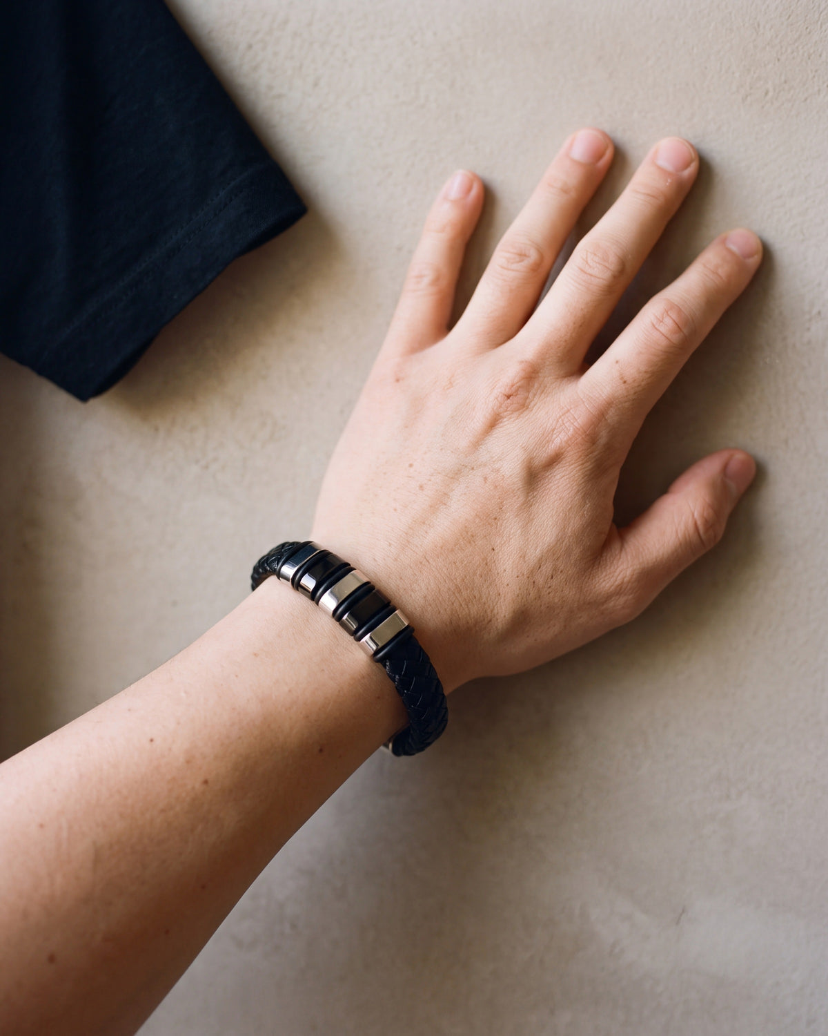 Close-up of the silver-tone Atlas two-tone bar braided leather bracelet worn at true size