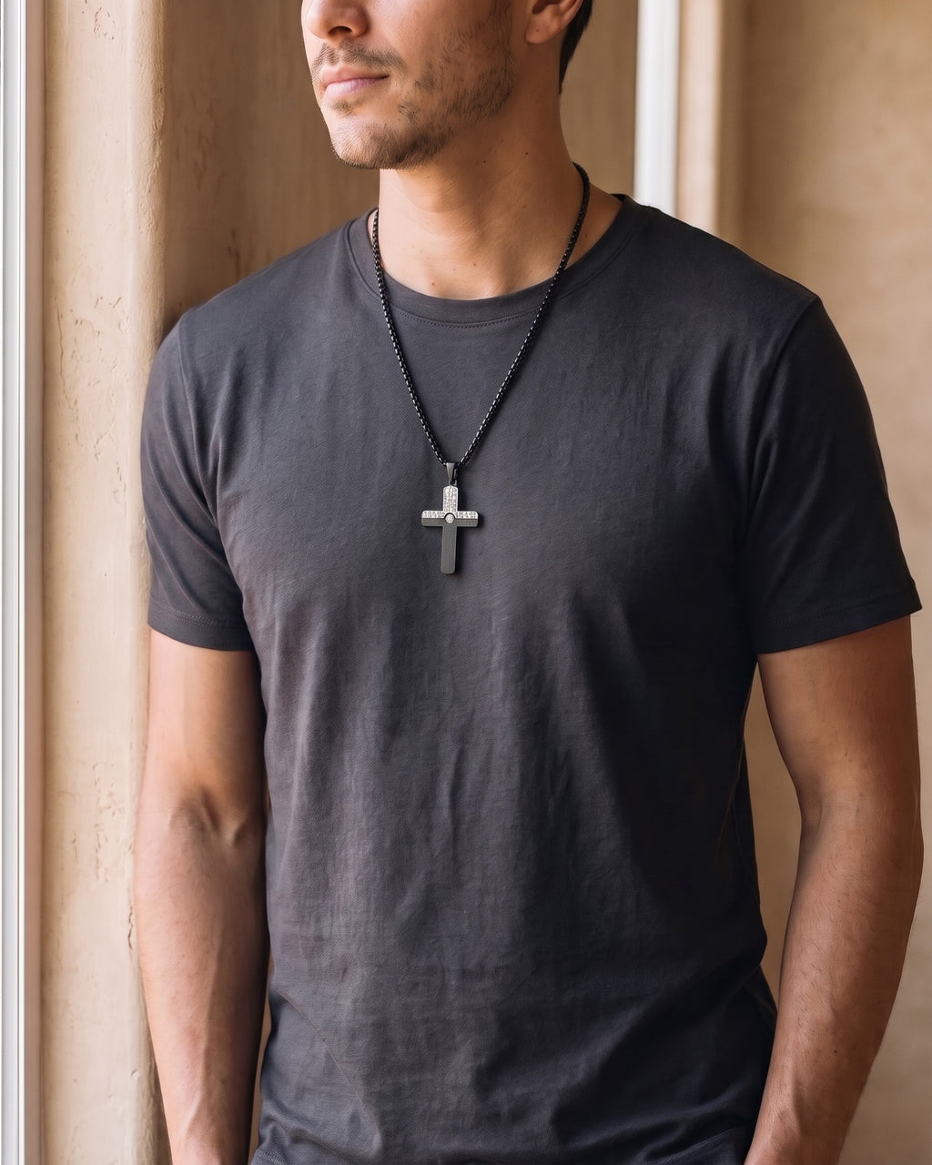 Man wearing the black Atlas Two-Tone Cross Necklace with CZ