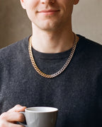 Close-up of the Atlas two-tone Cuban chain where the gold-tone and silver links meet