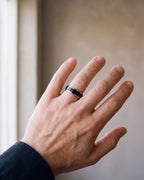 Close-up of the silver-tone Atlas two-tone spinner ring worn at true size
