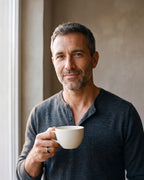 Second man in a fine-gauge charcoal-grey merino knit with a henley neckline wearing the silver-tone Atlas two-tone spinner ring