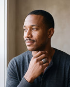 Man in a charcoal henley by a window wearing the antiqued silver-tone Atlas Viking knotwork ring