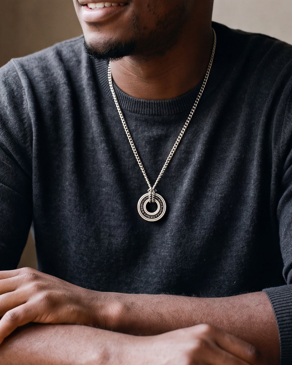 Close-up of the Atlas Viking rune circle pendant necklace in silver-tone steel, worn at true size