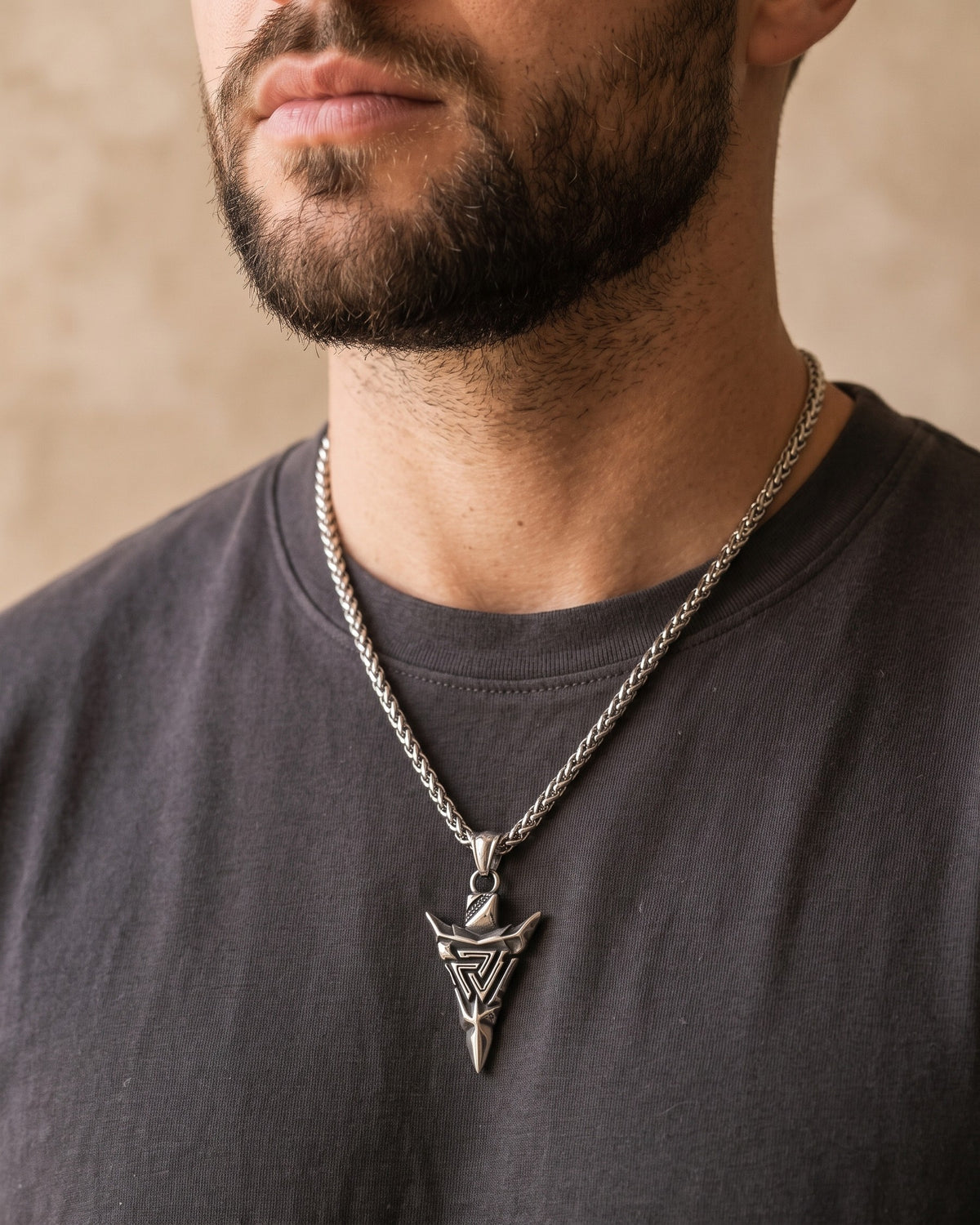 Close-up of the Atlas Viking Valknut Arrow Necklace worn by a man, shown at true size