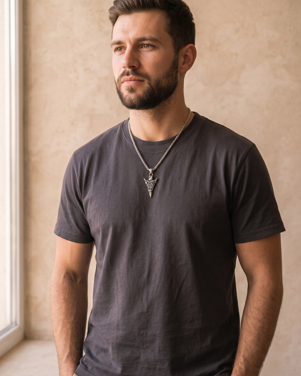 Man wearing the silver Atlas Viking Valknut Arrow Necklace