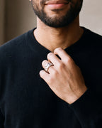Close-up of the Atlas watch link band ring in silver-tone steel, worn at true size