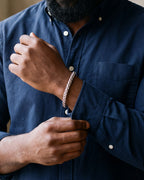 Close-up of the Atlas wheat chain bracelet on a man's wrist at true size