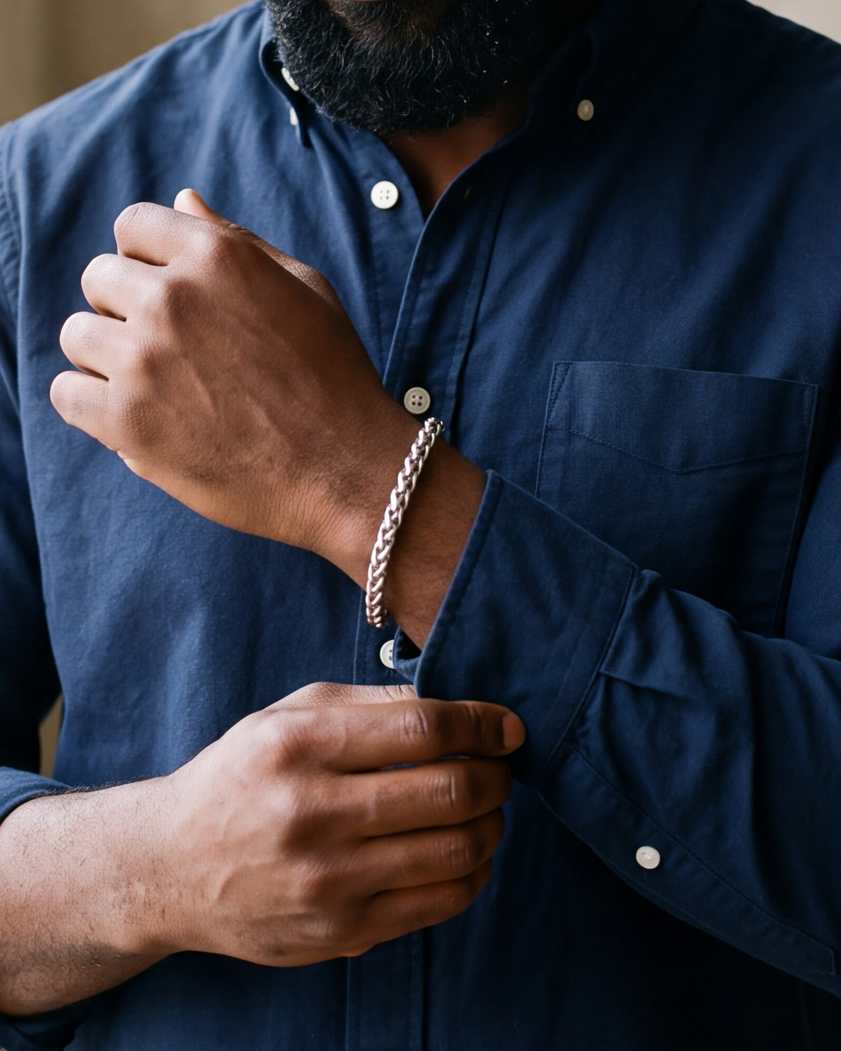 Close-up of the Atlas wheat chain bracelet on a man's wrist at true size