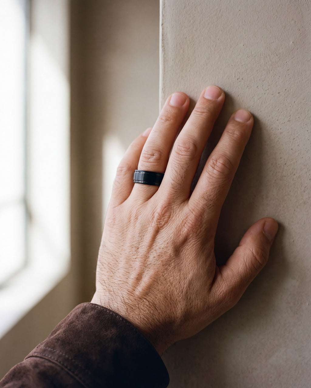 Close-up of the black Atlas Wine Barrel Wood Ring worn at true size