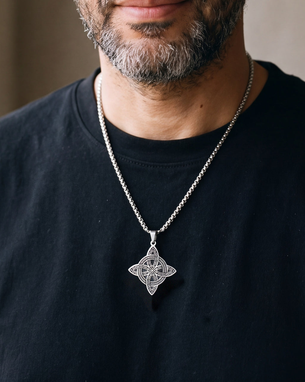 Close-up of the silver-tone Atlas Celtic witch's knot pendant worn on the chest at true size