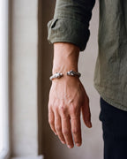 Close-up of the silver-tone Atlas wolf head braided cuff bracelet worn at true size