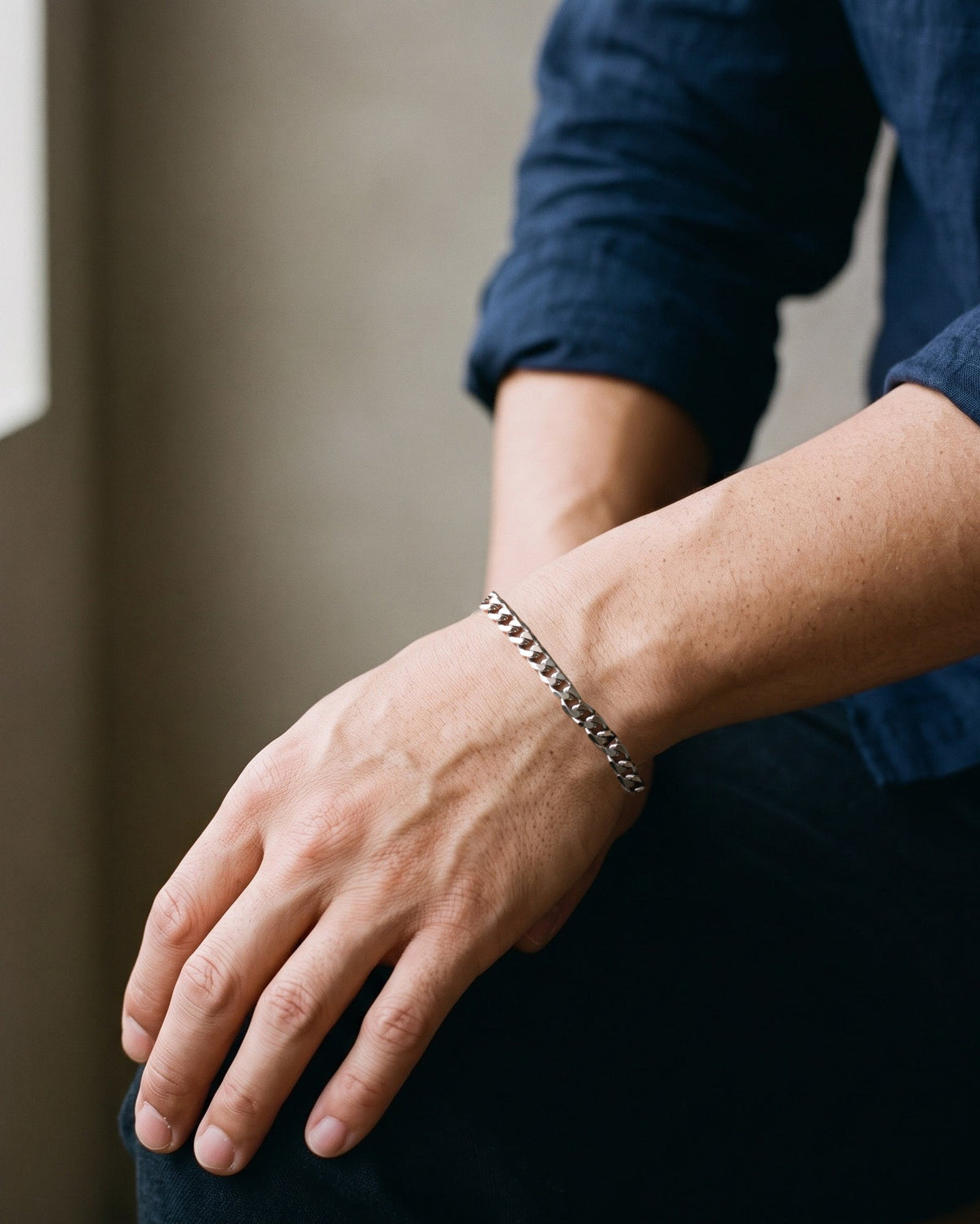 Close-up of the silver-tone Atlas Diamond-Cut Cuban Bracelet worn on the wrist, true size