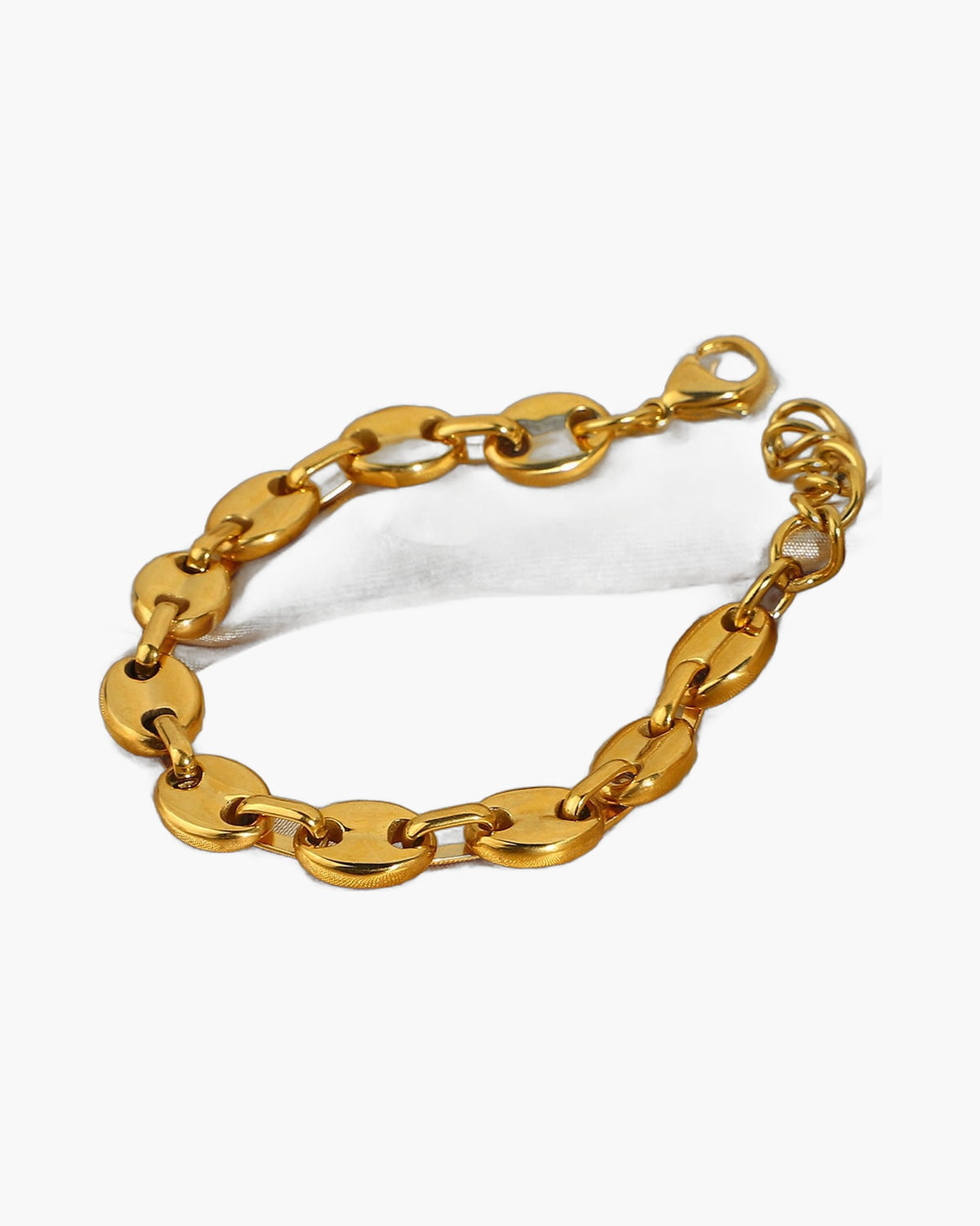 Gold-Tone Coffee Bean Link Bracelet on a light gold fabric background view 3