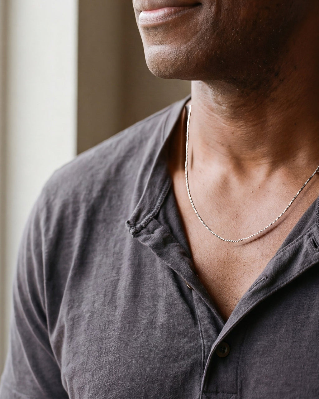 Close-up of the silver Atlas minimalist box chain worn, true size
